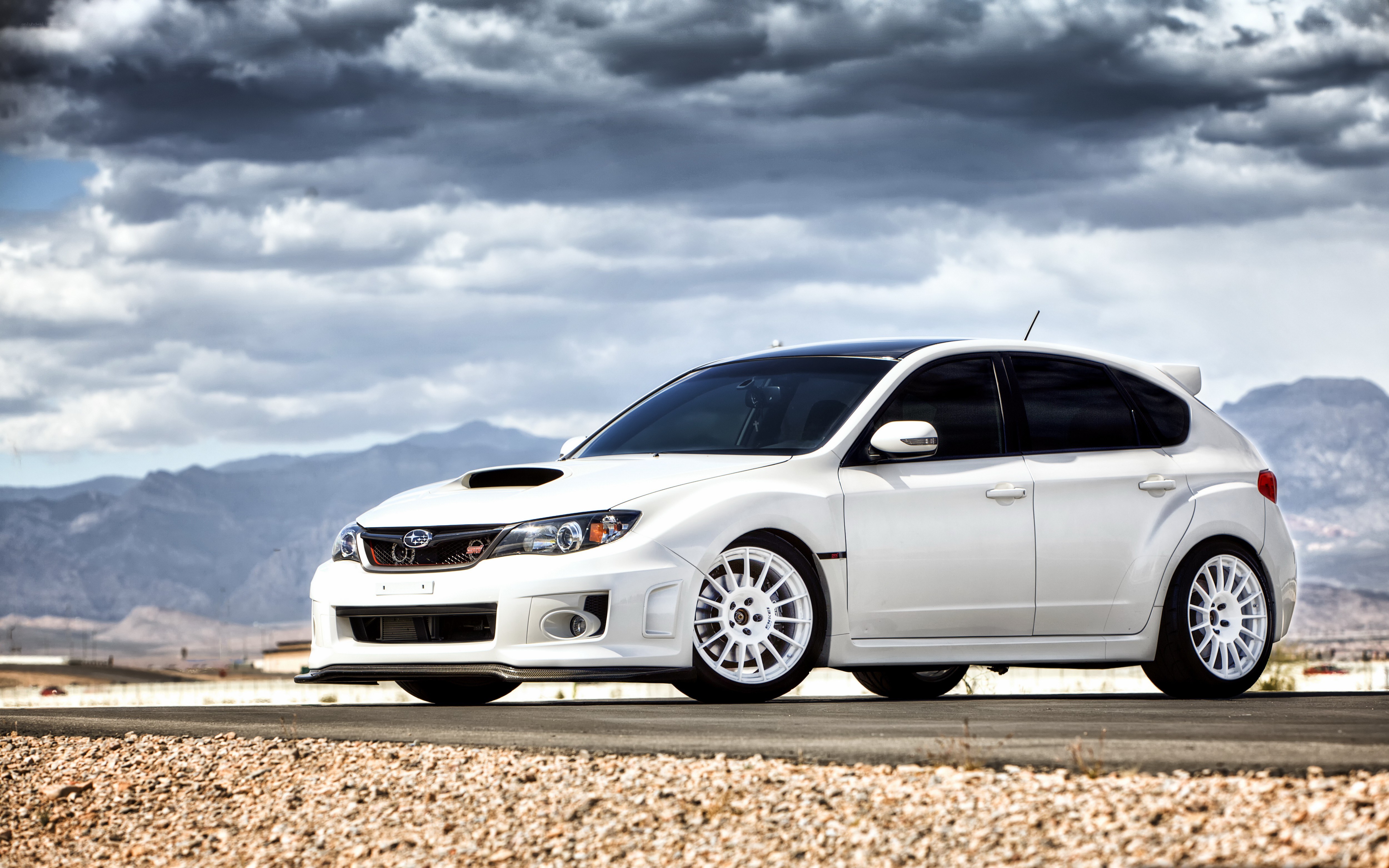 White Subaru WRX on a desert road