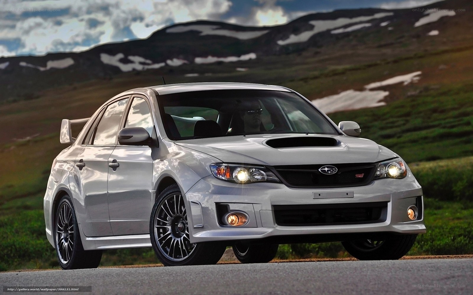 White Subaru WRX on mountain road