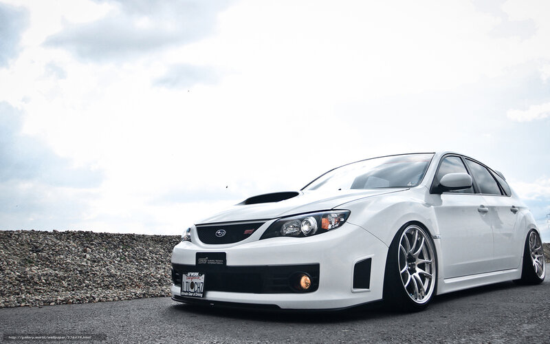 white subaru wrx sti on asphalt
