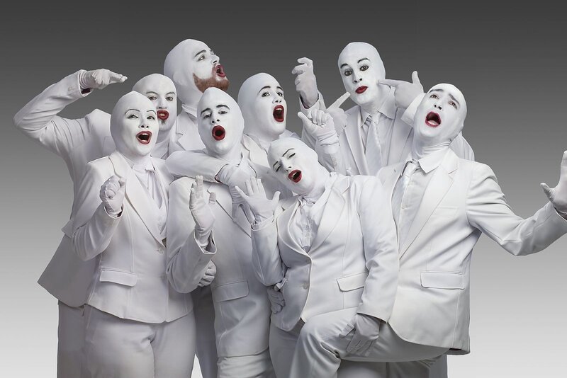 White-suited performers in a group