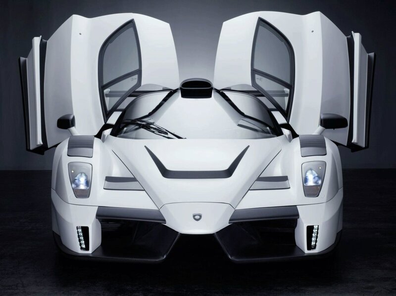 white supercar with doors open