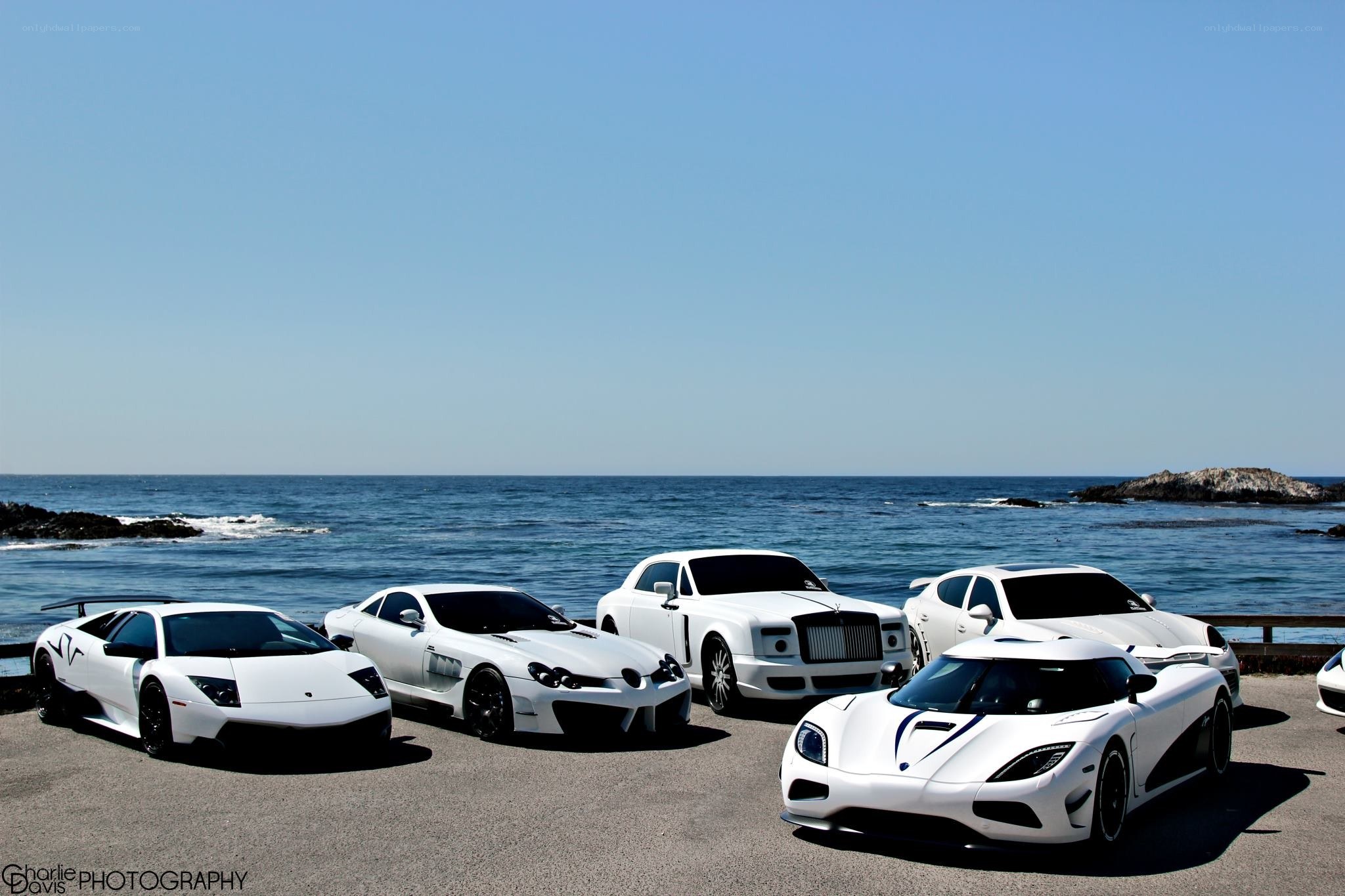 White supercars by the ocean