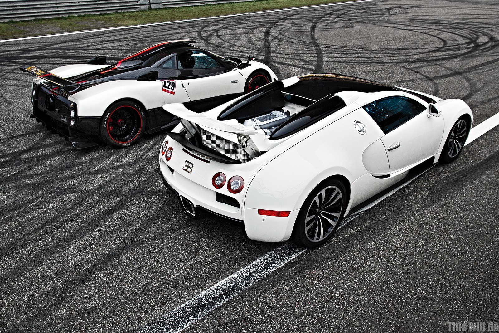 White supercars on a racetrack