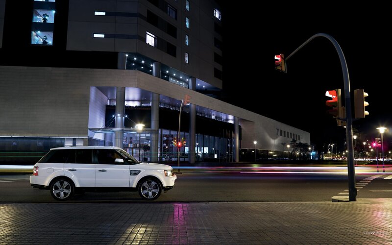 White SUV at night on city street