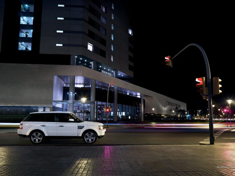 White SUV at night on city street