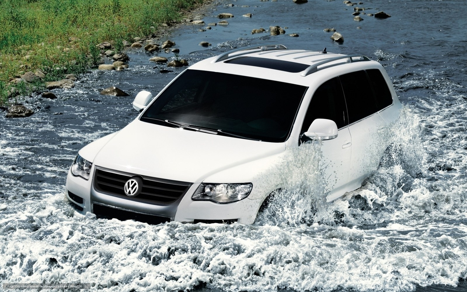 White SUV crossing a river