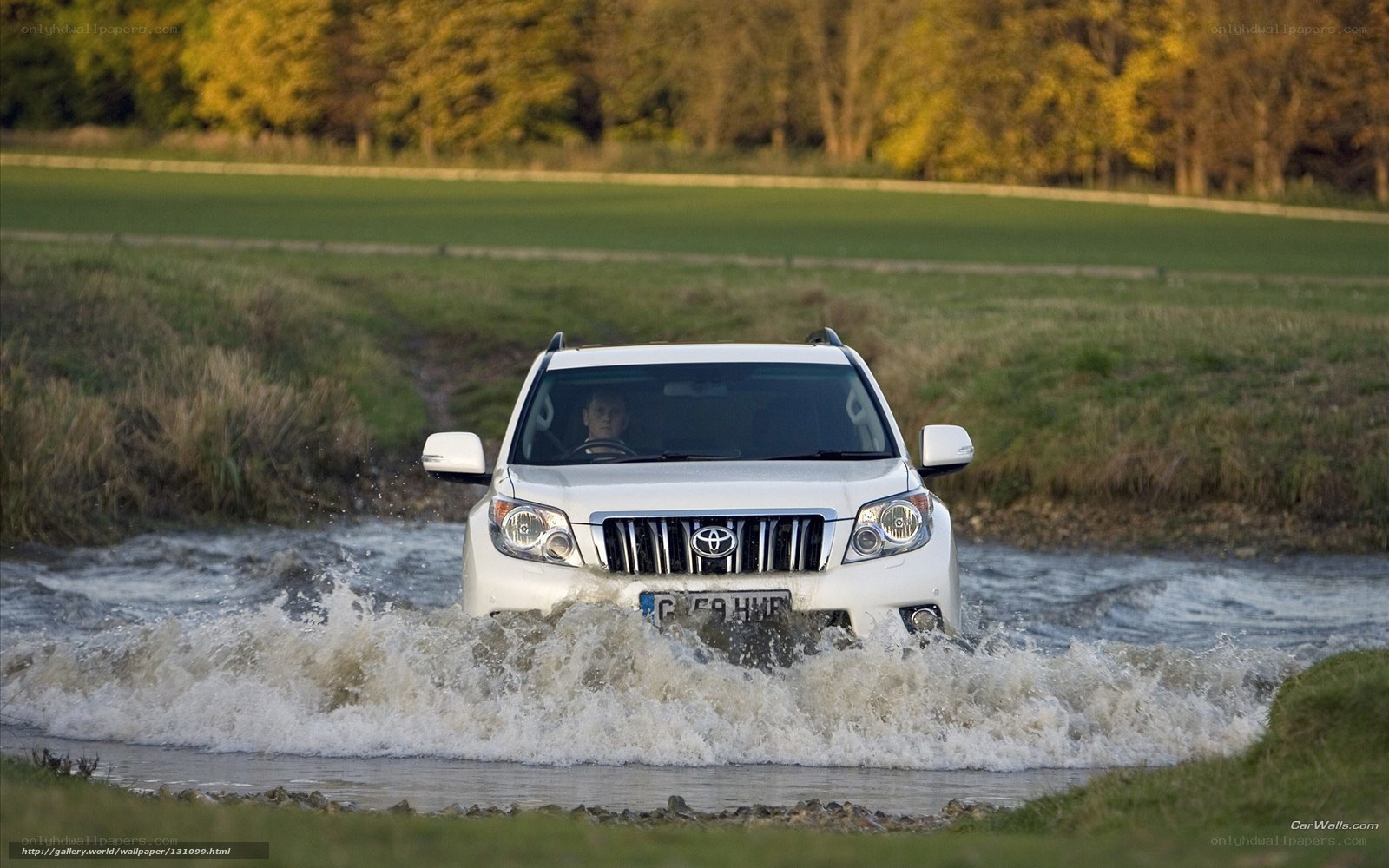White SUV crossing a river