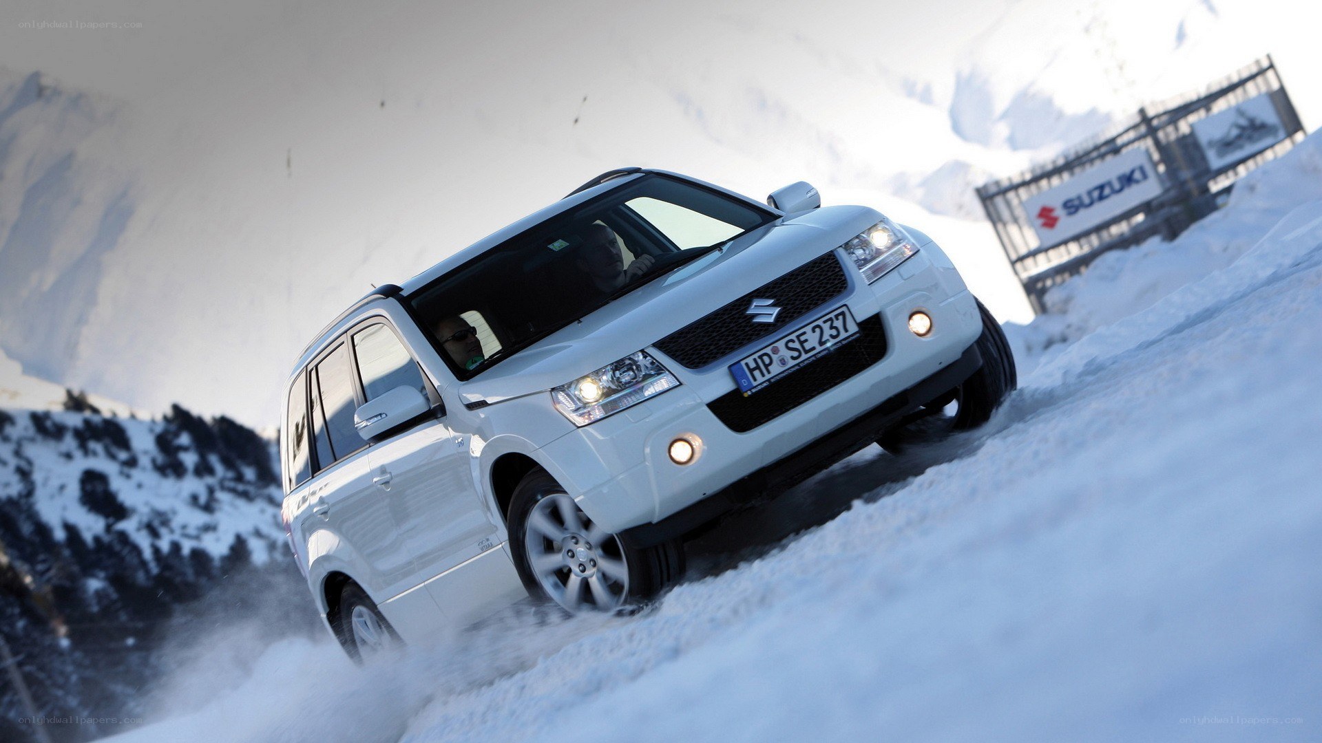 White SUV driving in snow