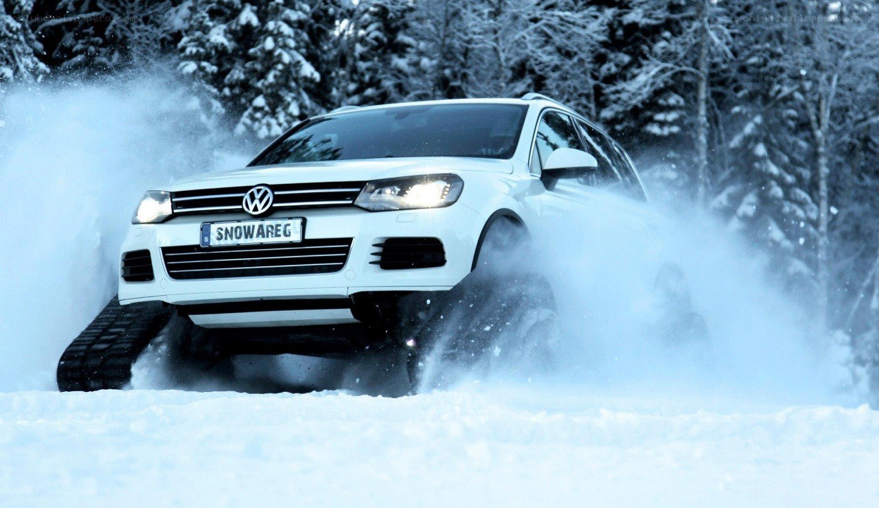 White SUV driving in snow
