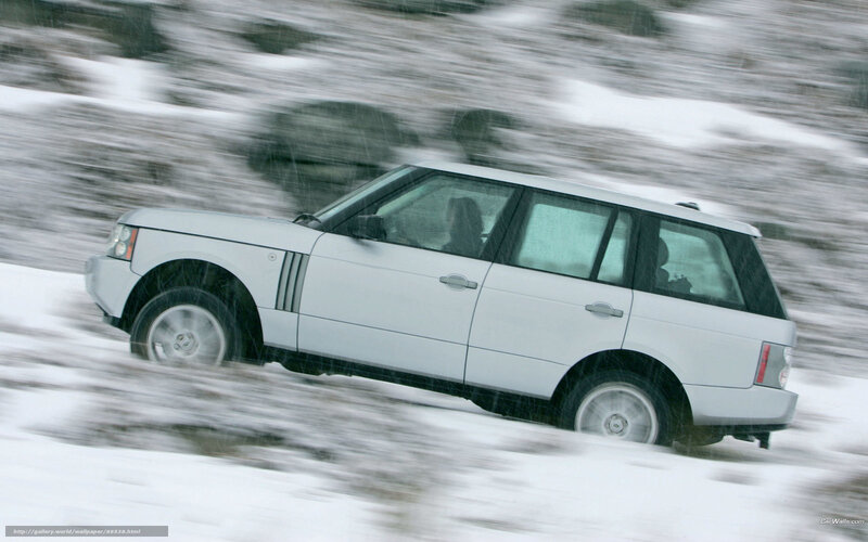 White SUV driving in snow