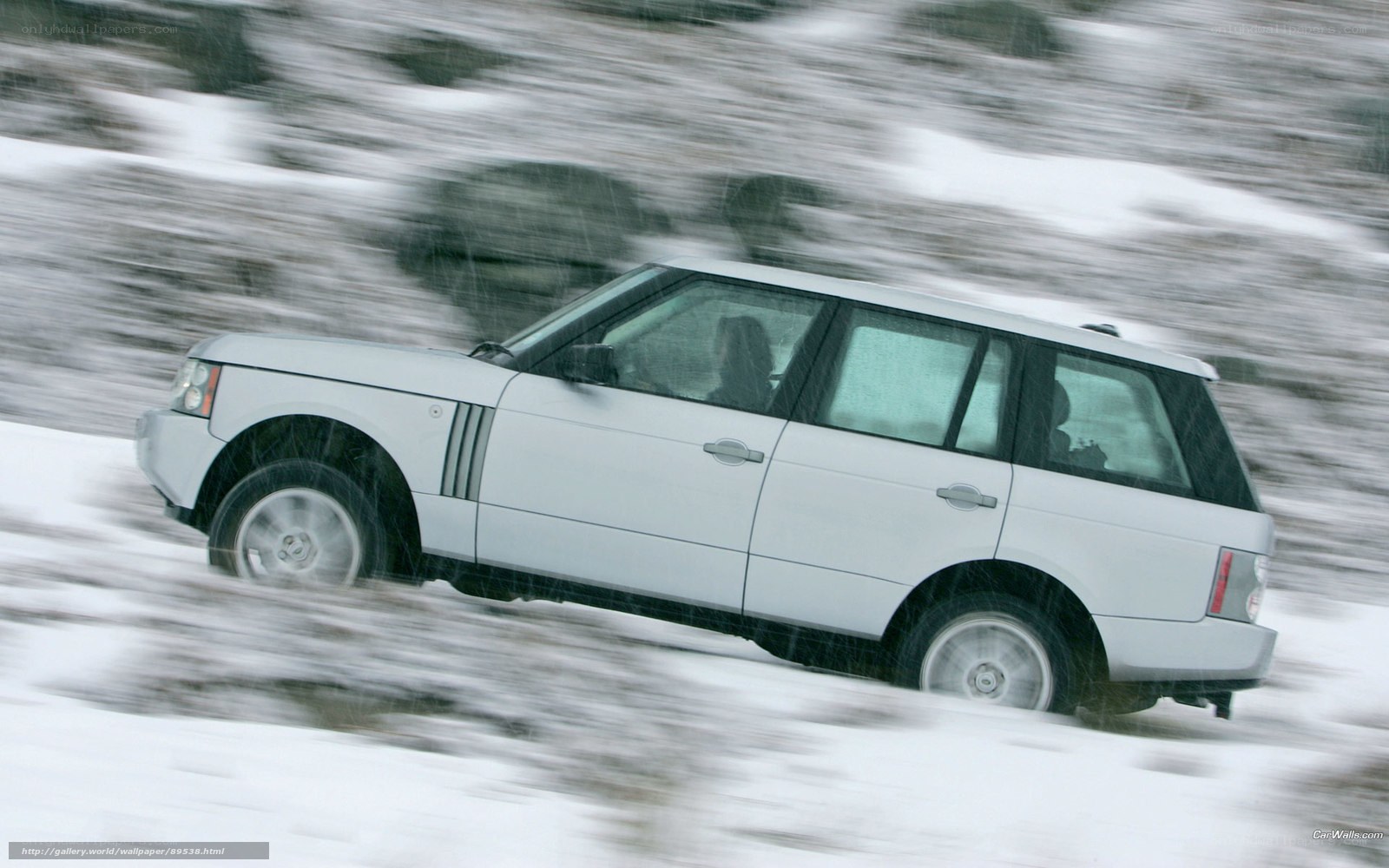White SUV driving in snow