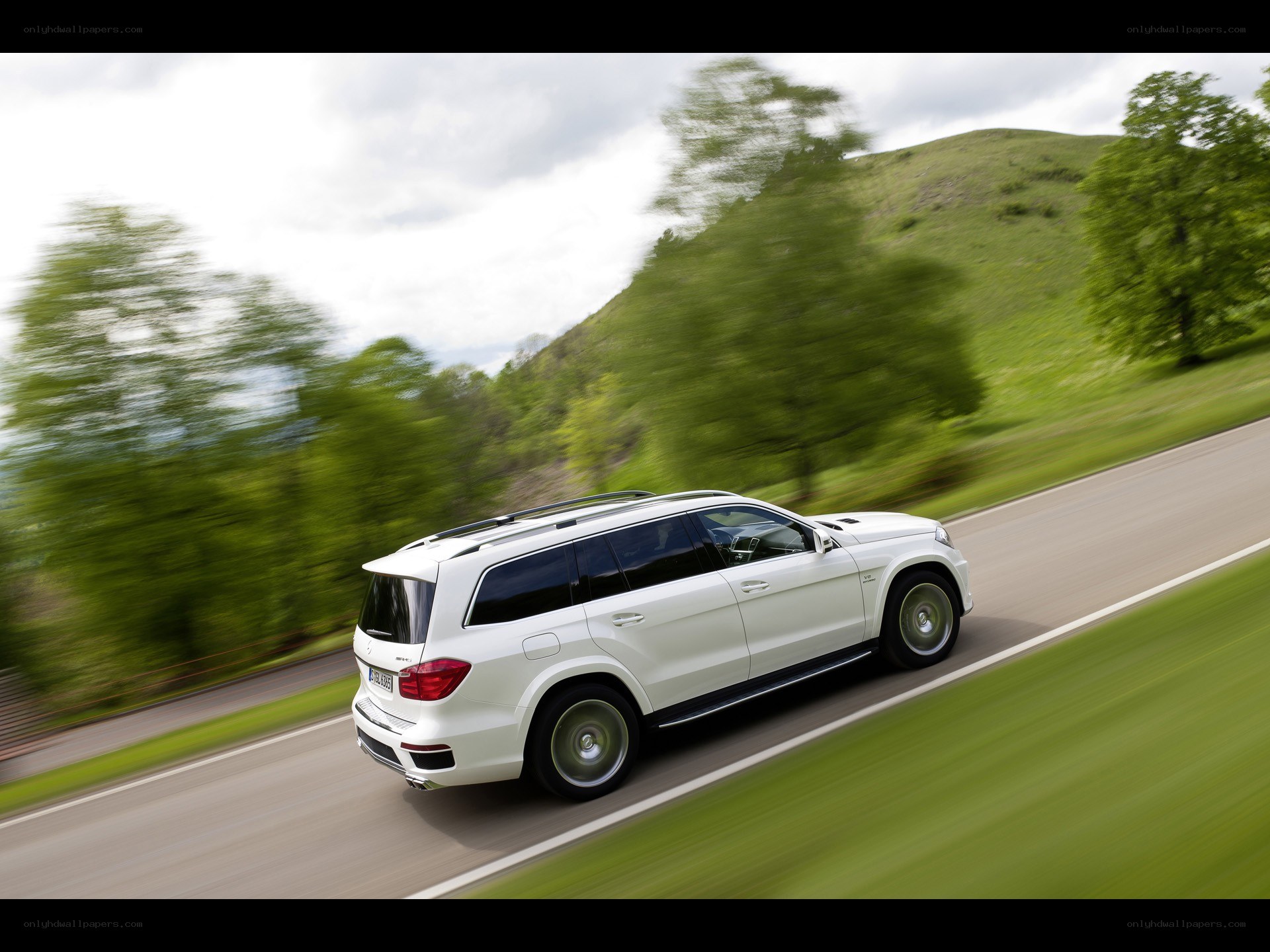 White SUV driving on a road