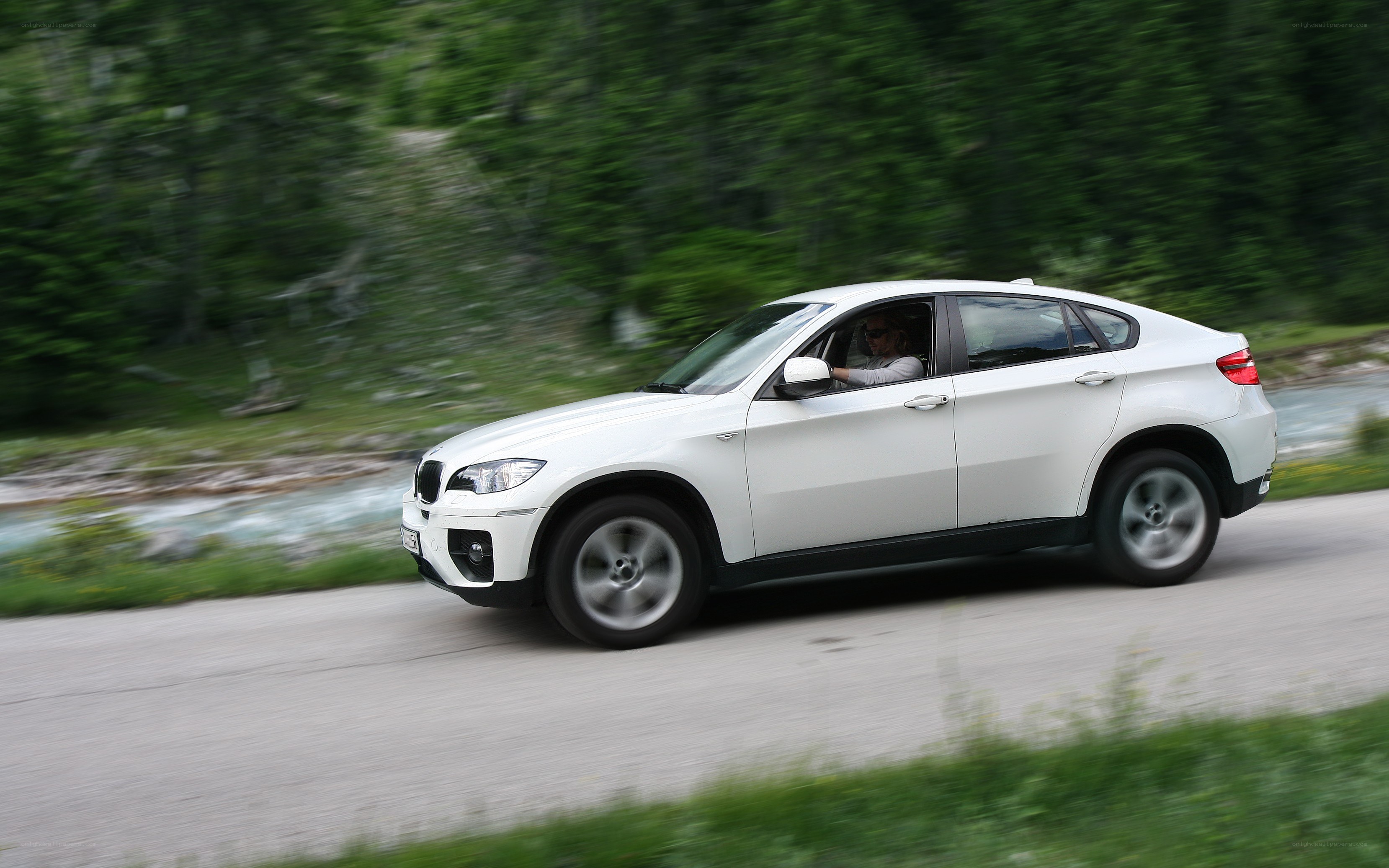 White SUV driving on a road