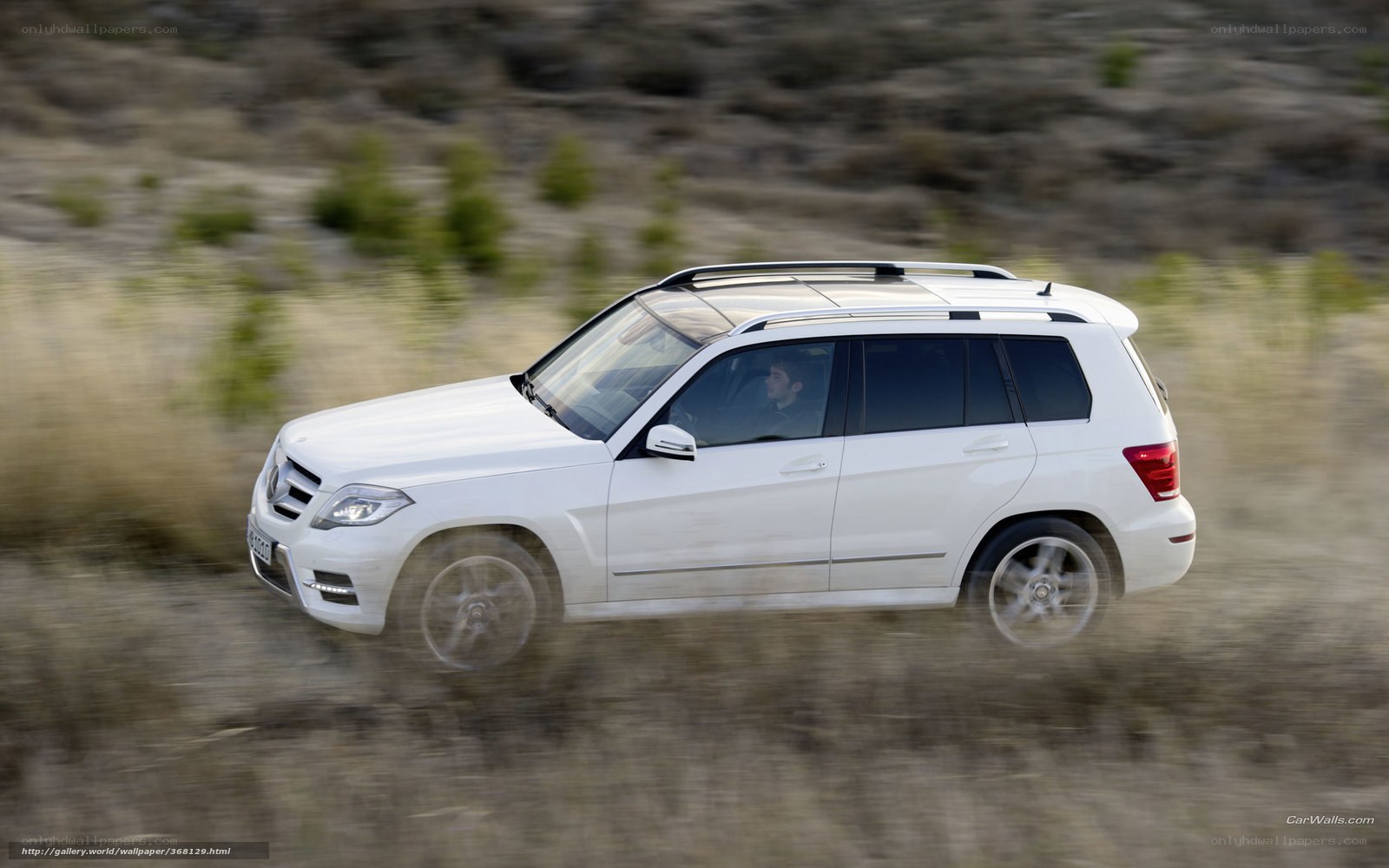 white suv driving on dirt road