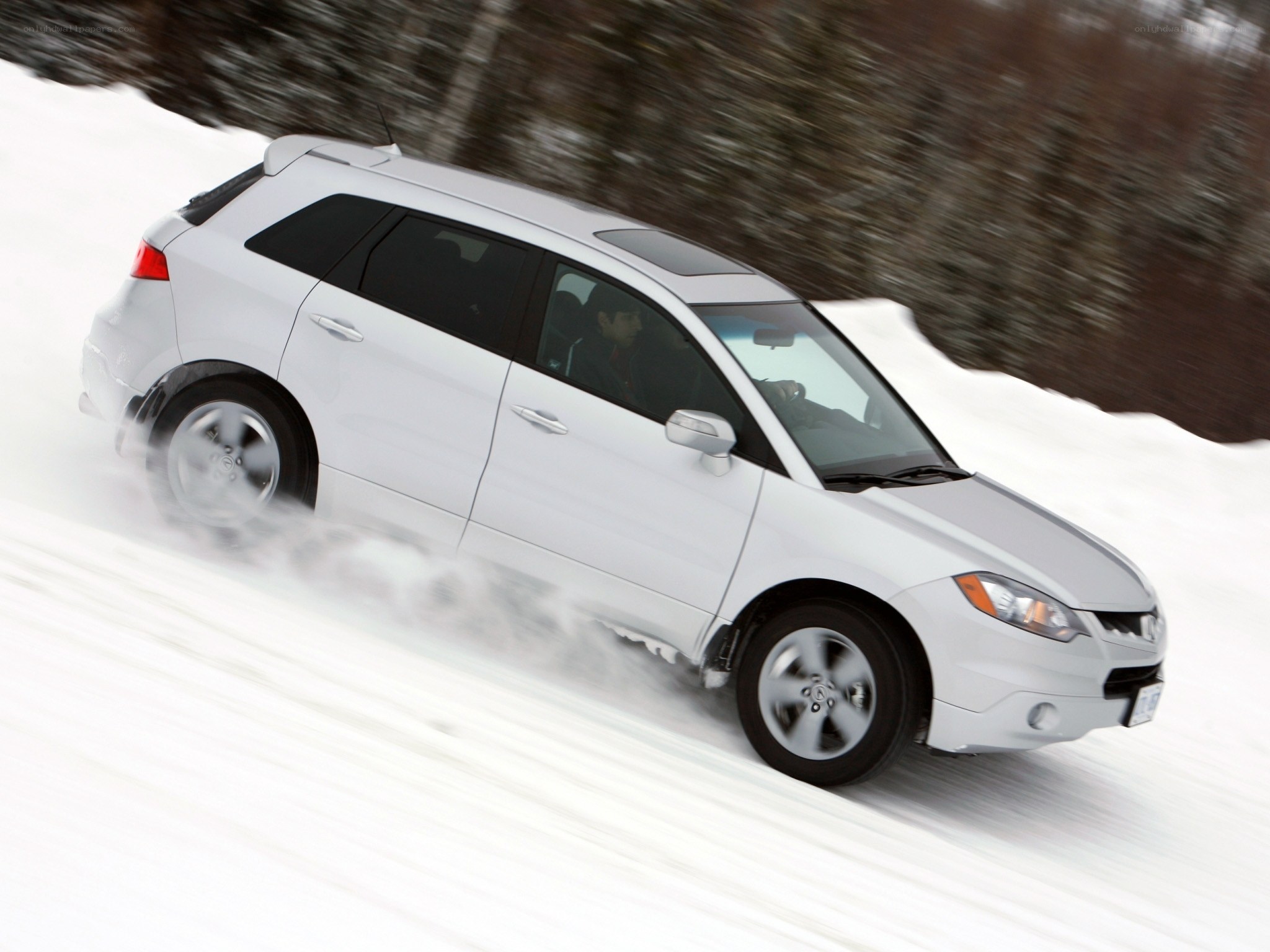 white suv driving on snow