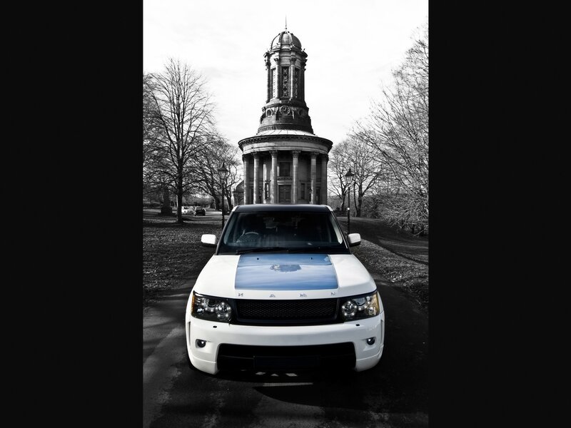 White SUV in front of a clock tower