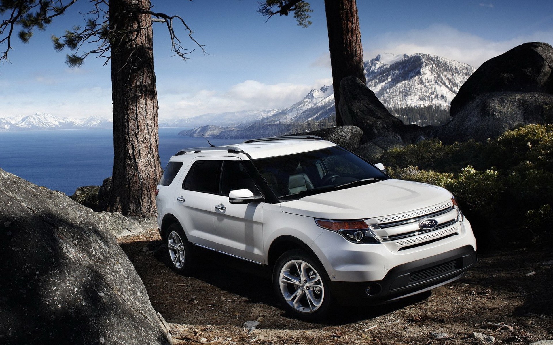 White SUV in mountain landscape