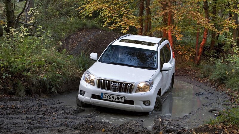 White SUV in muddy forest
