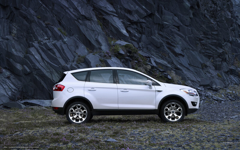 White SUV in rocky landscape