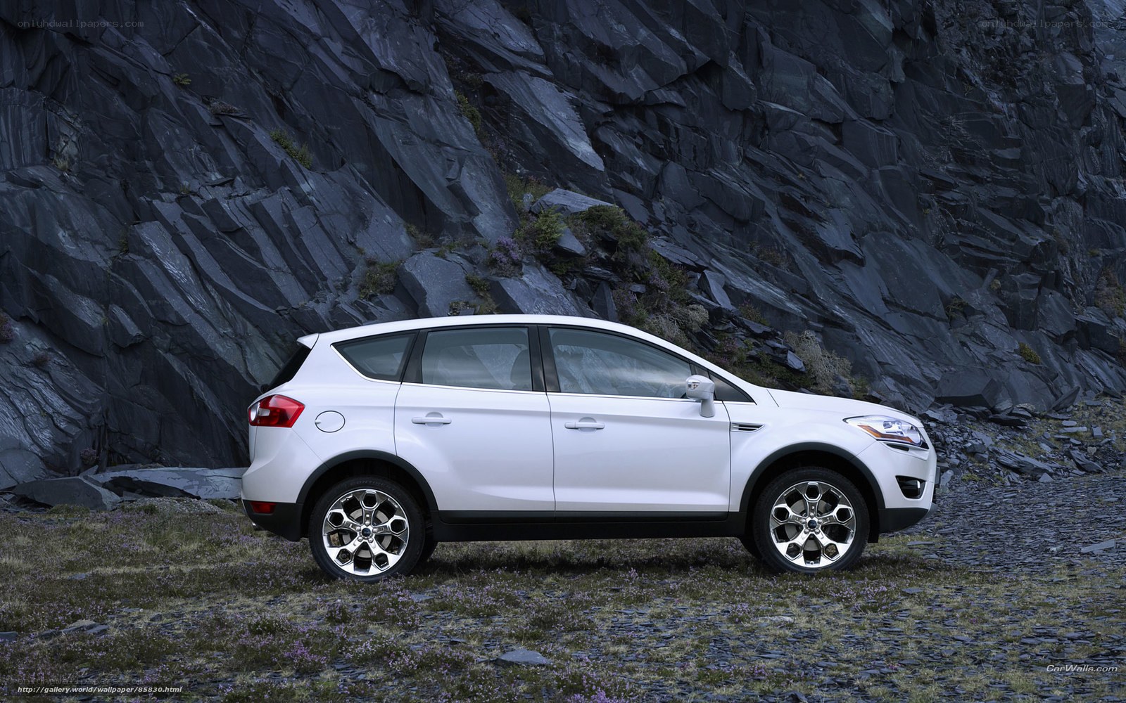 White SUV in rocky landscape
