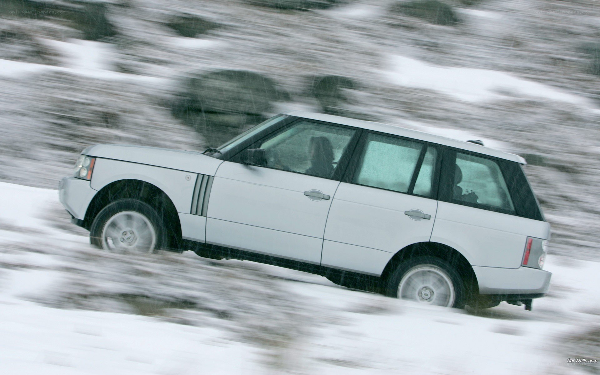 white SUV in snowy landscape