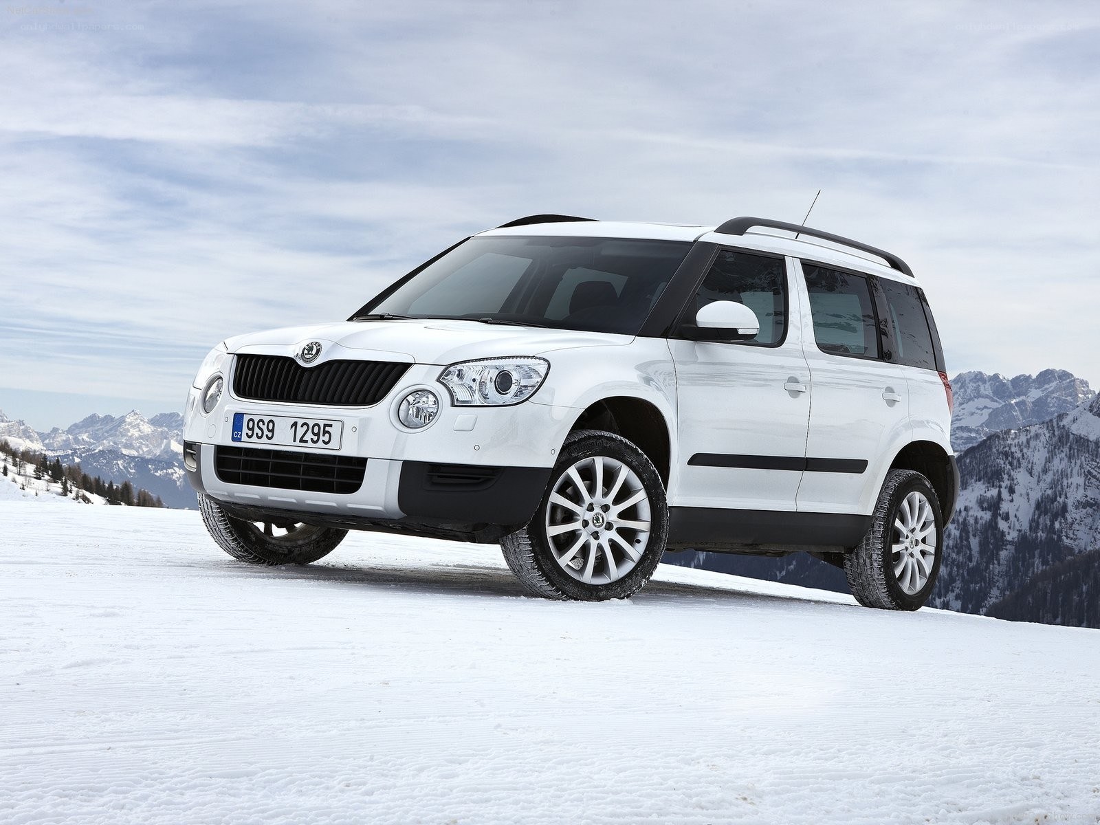 White SUV in snowy mountains