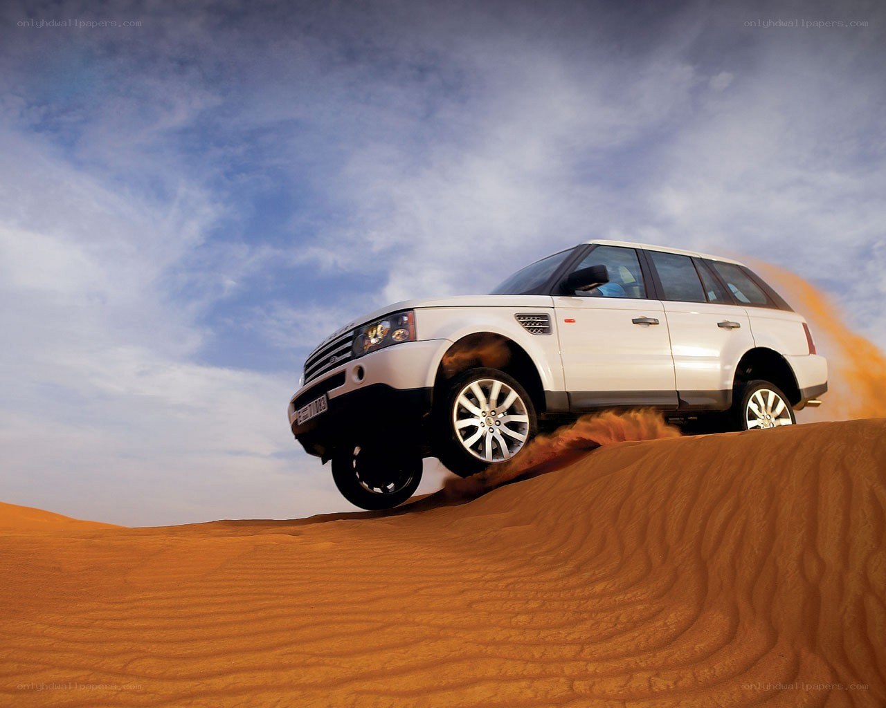 White SUV on desert dune