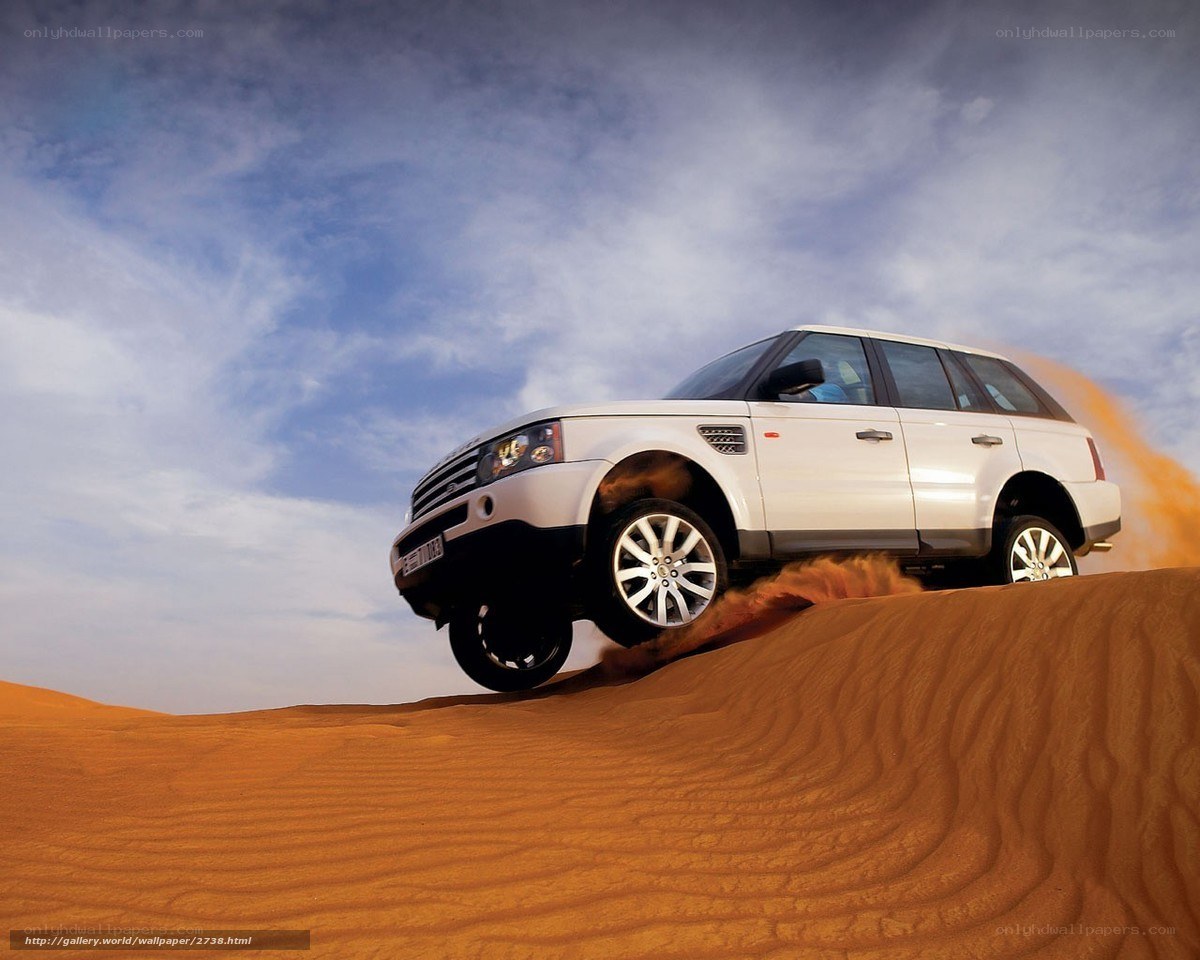 White SUV on desert dune