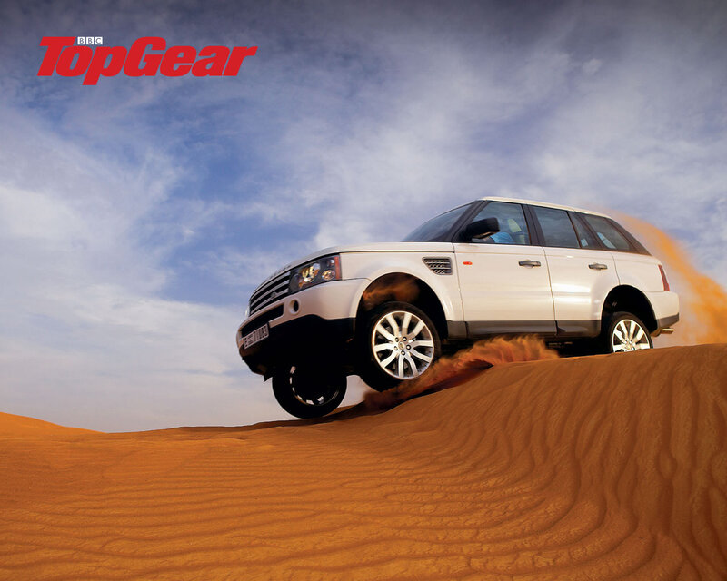 White SUV on sand dune
