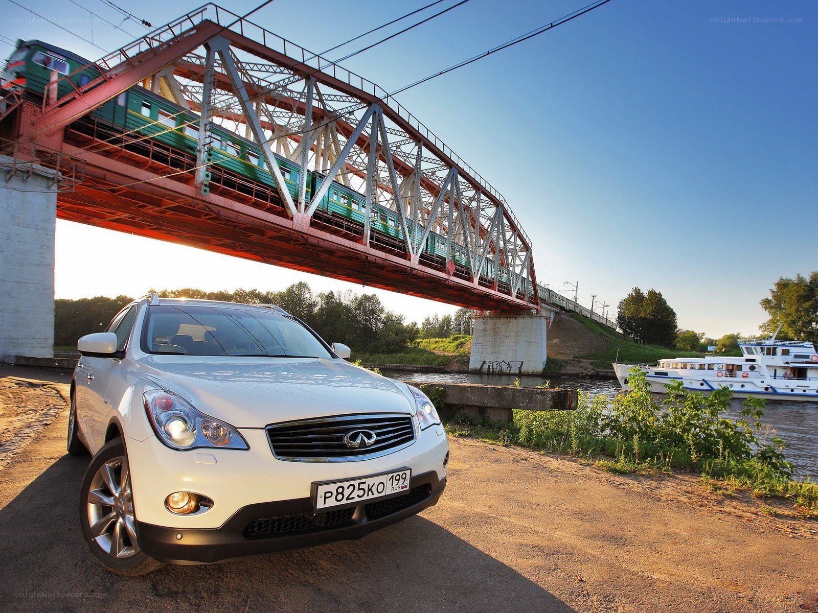 White SUV under a train bridge