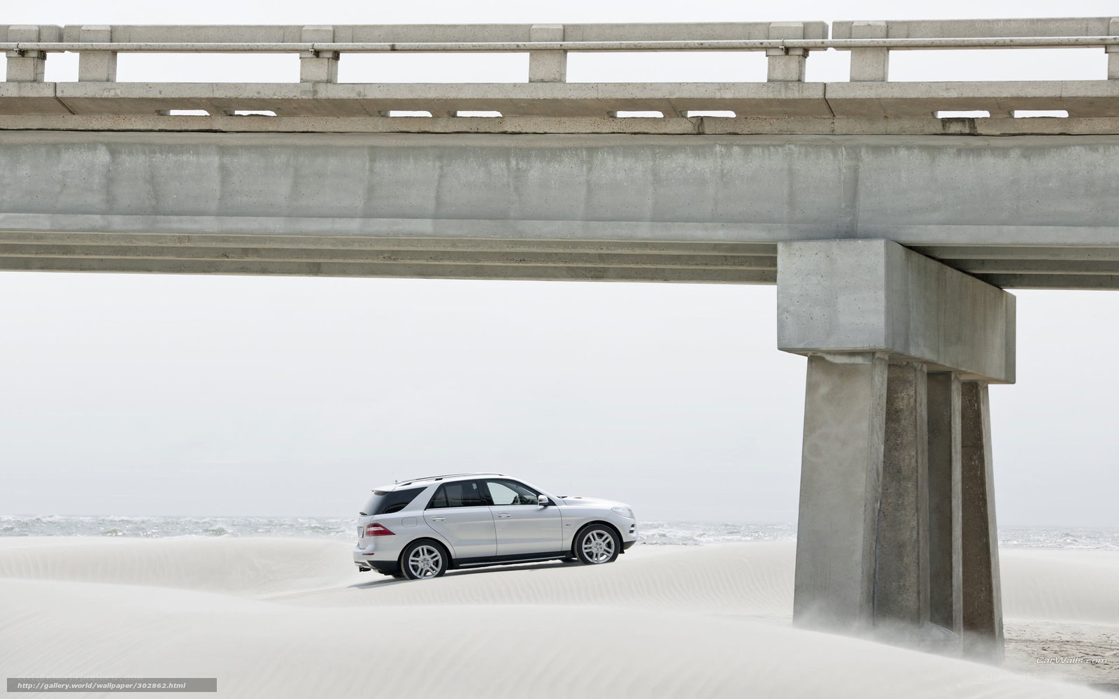 White SUV under concrete bridge
