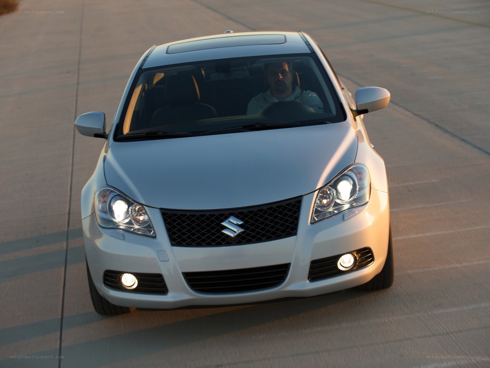 white suzuki car on road