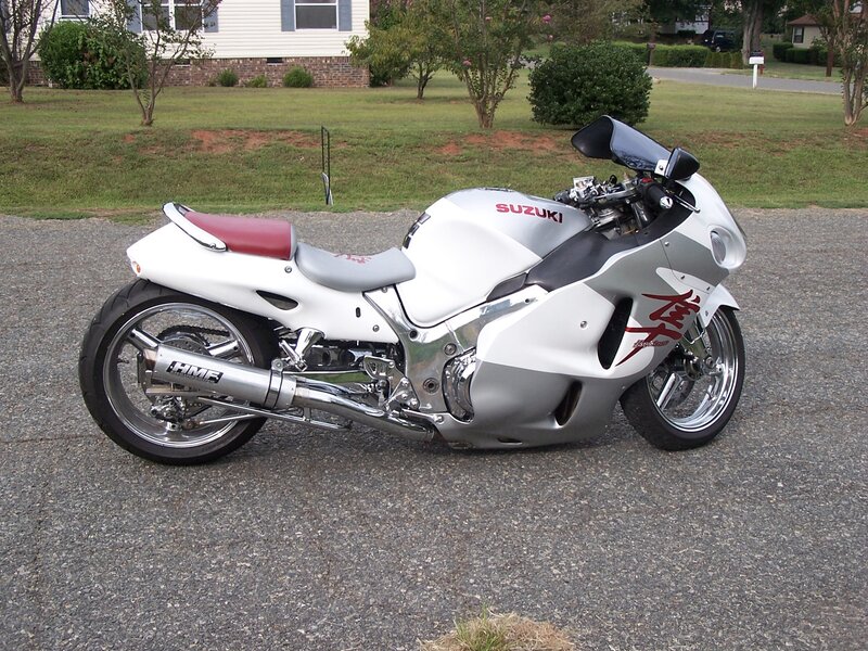 White Suzuki motorcycle on driveway