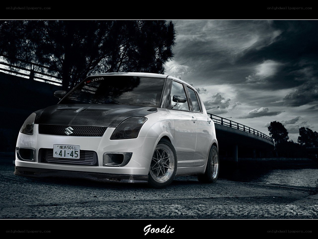 White Suzuki Swift on a bridge