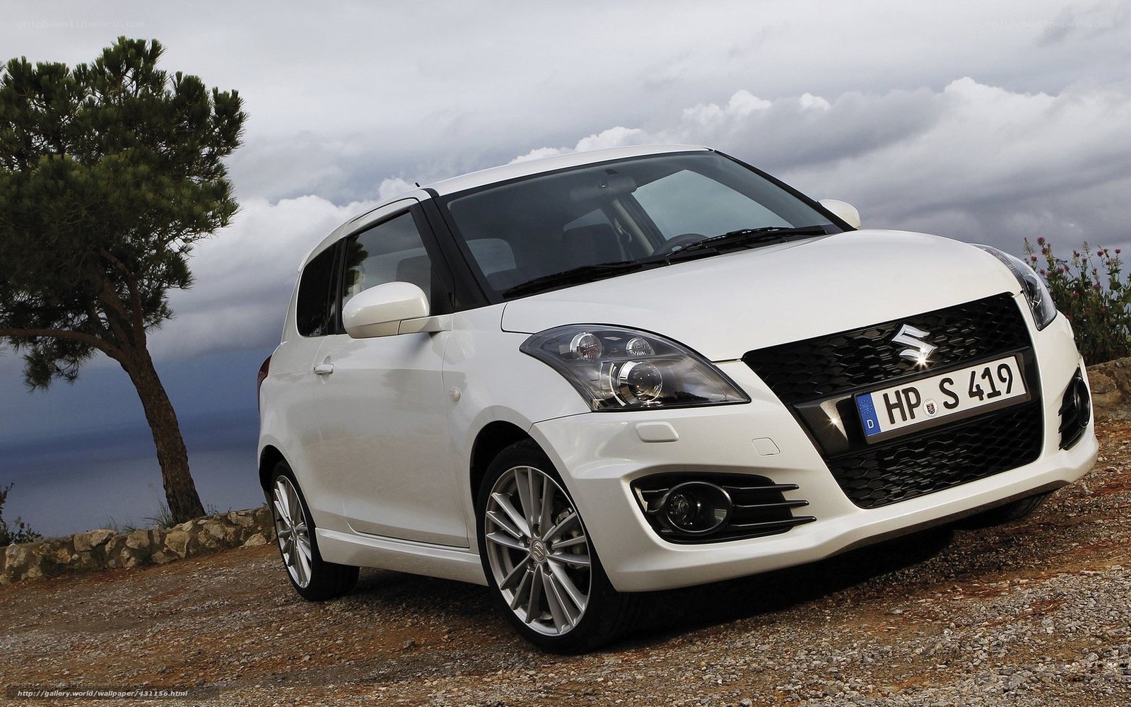 White Suzuki Swift on a cliff