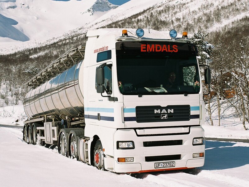 White tanker truck in snowy mountains