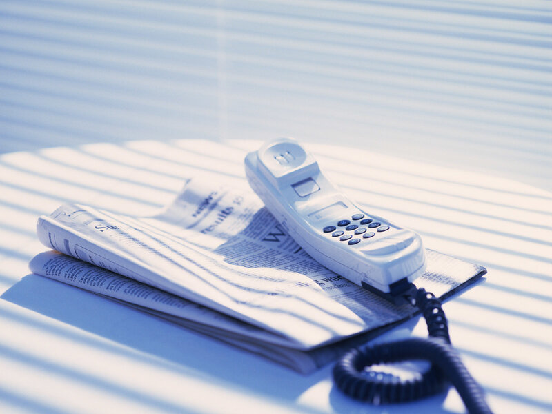 White Telephone on Newspaper