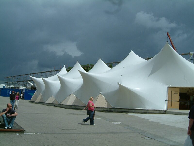 White tents under stormy sky