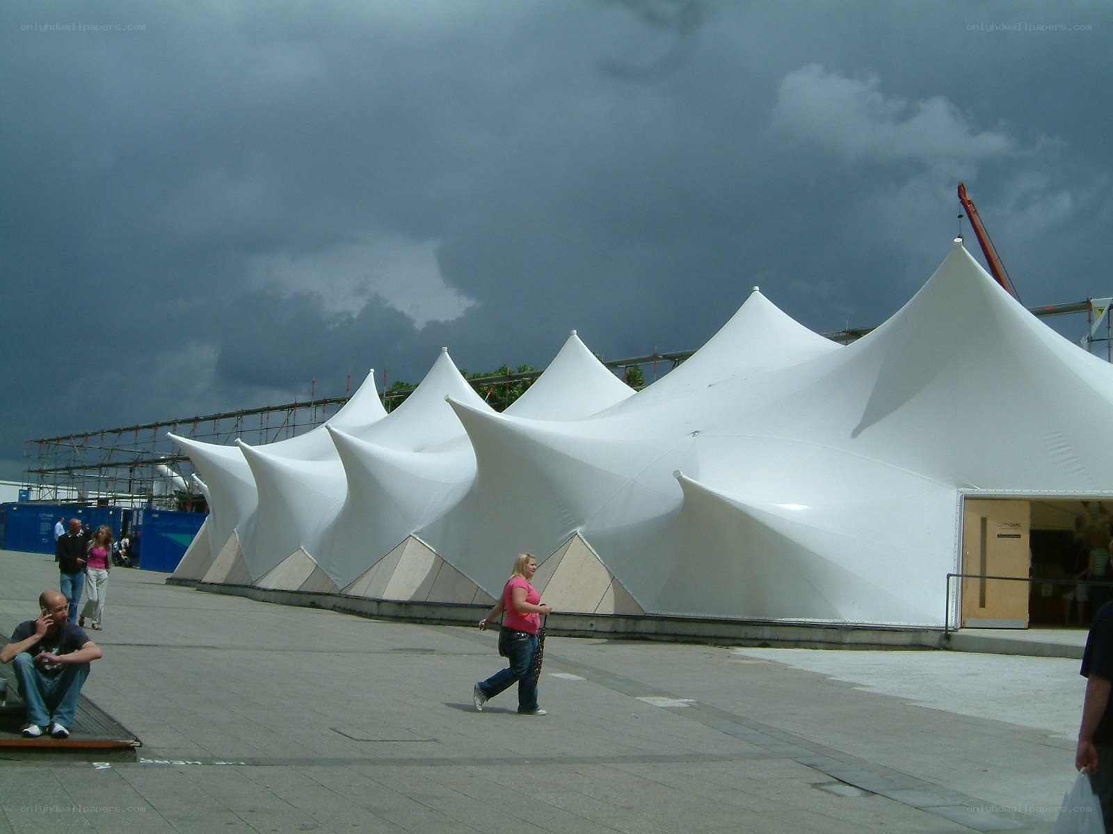 White tents under stormy sky