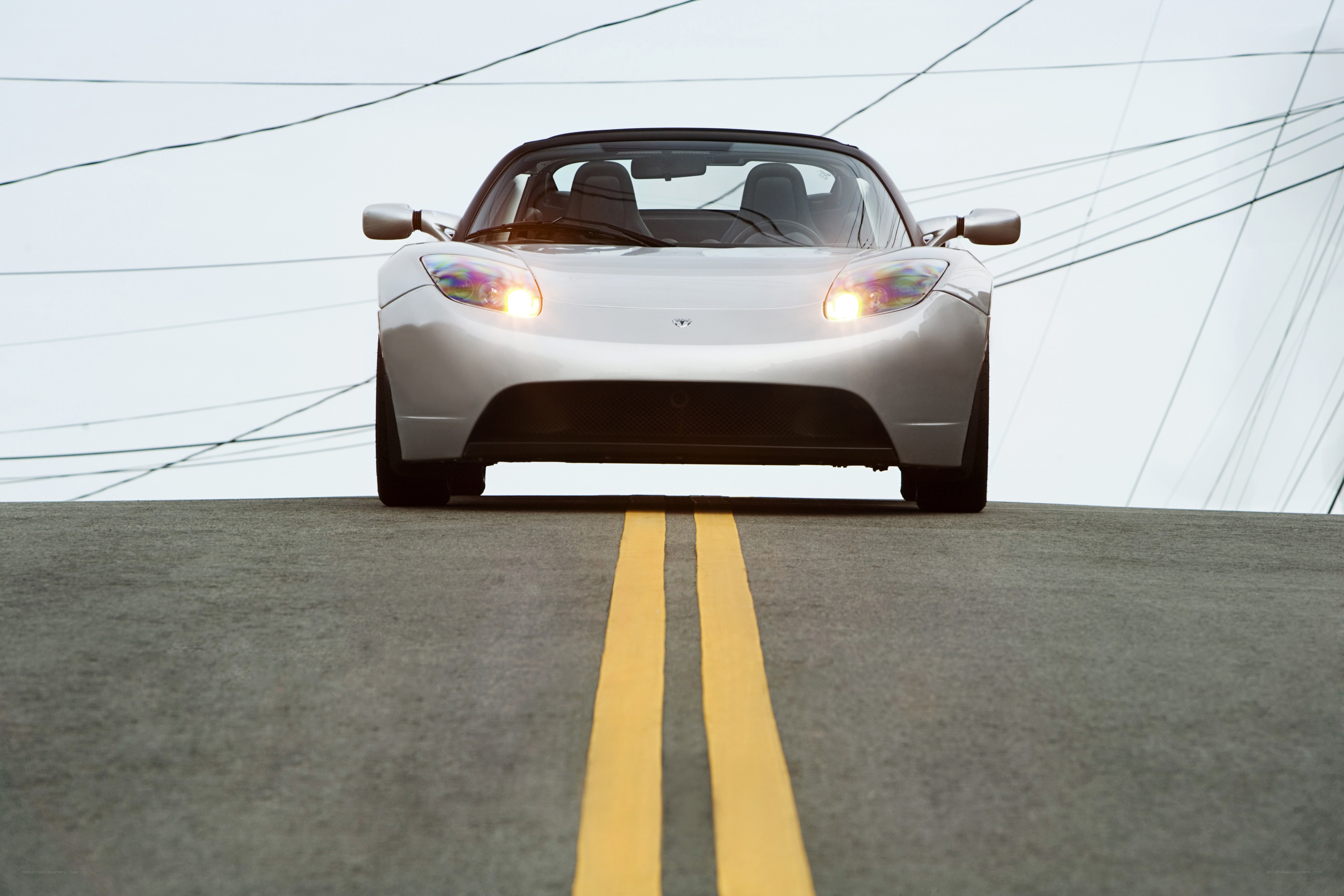 White Tesla Roadster on road