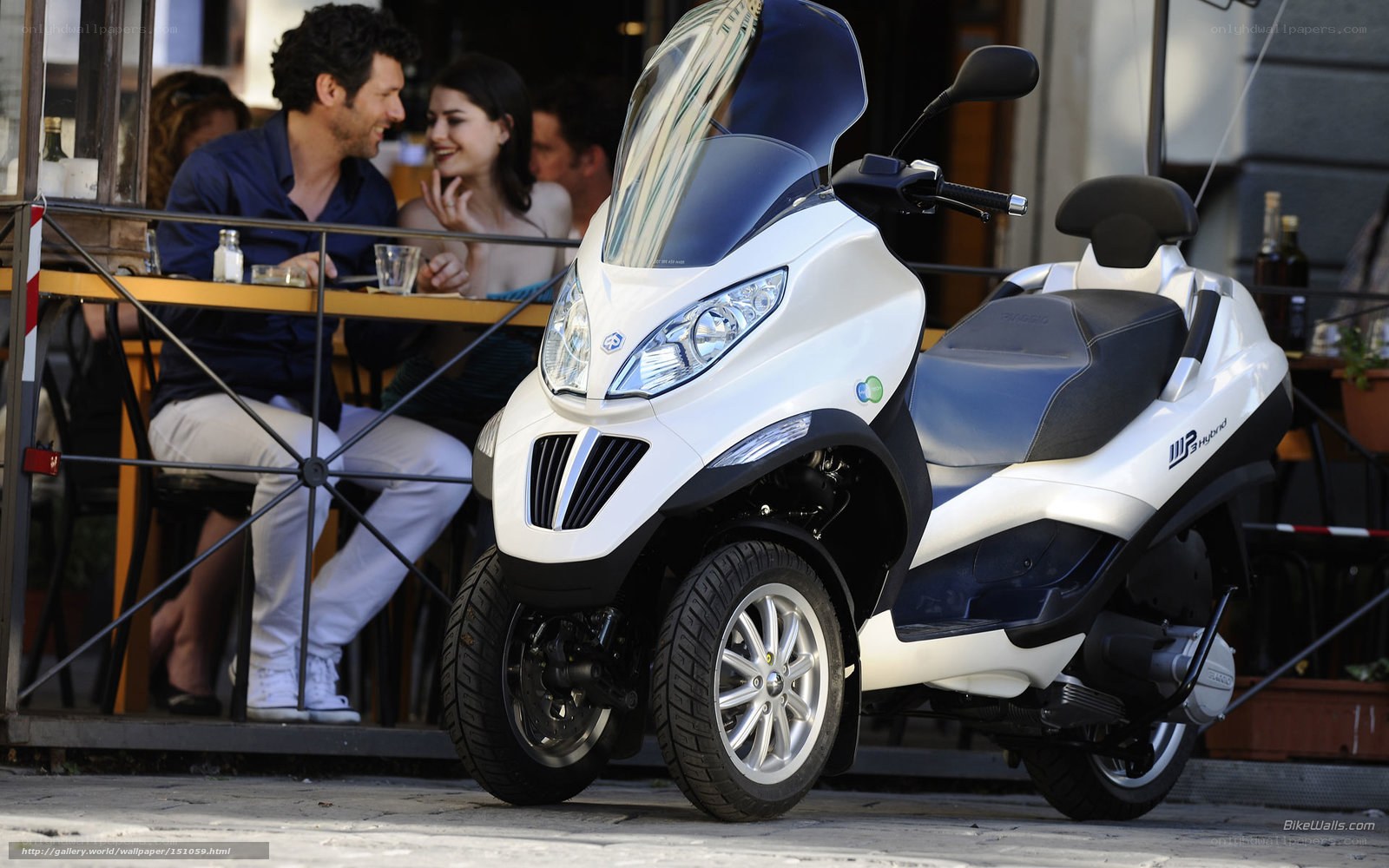 White three-wheeled scooter at cafe