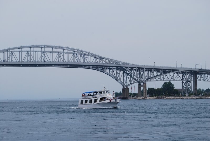 White Tour Boat under Bridge