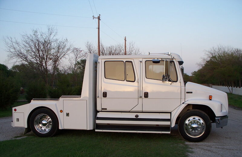 white tow truck on grass