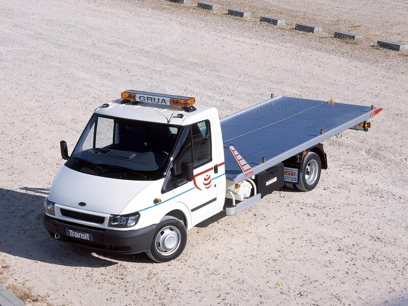 white tow truck on gravel