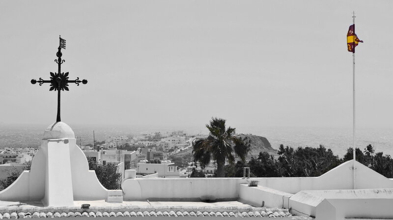 White town with cross and flag