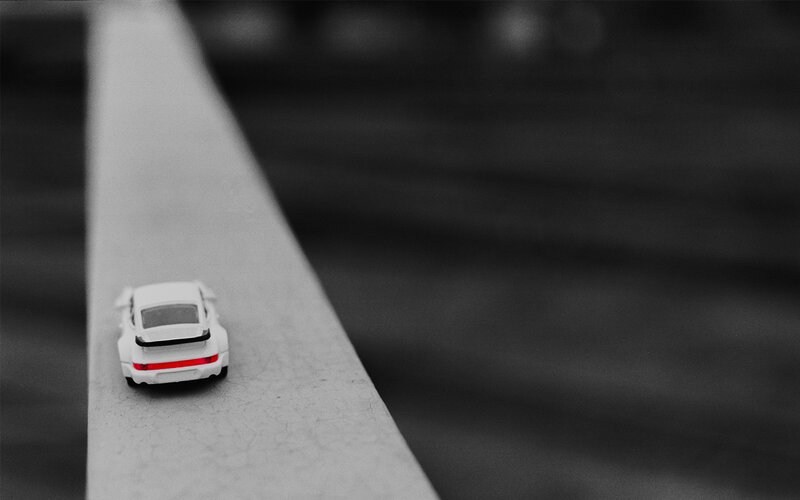 White Toy Car on Surface — Black
