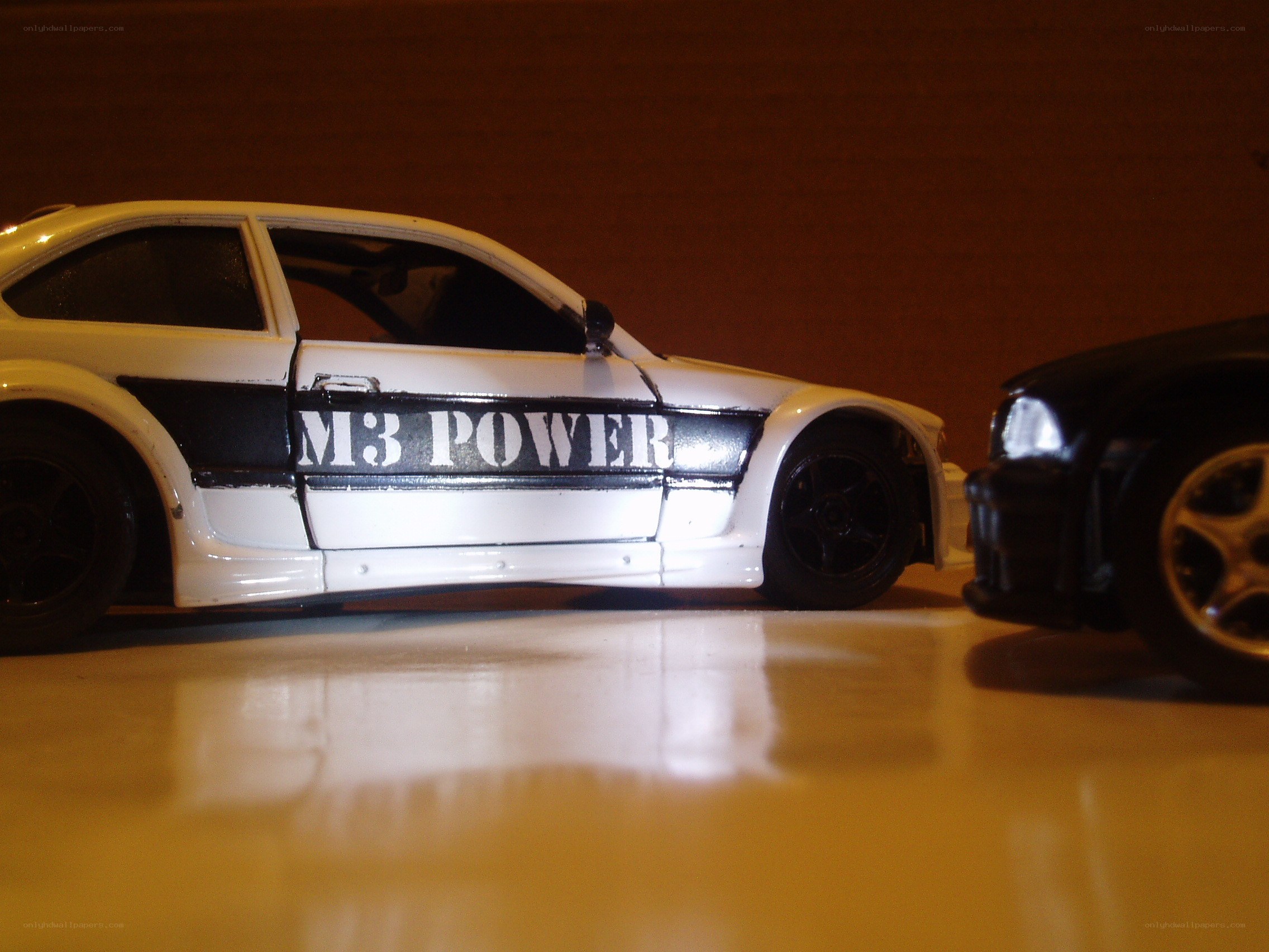 white toy car with M3 POWER text
