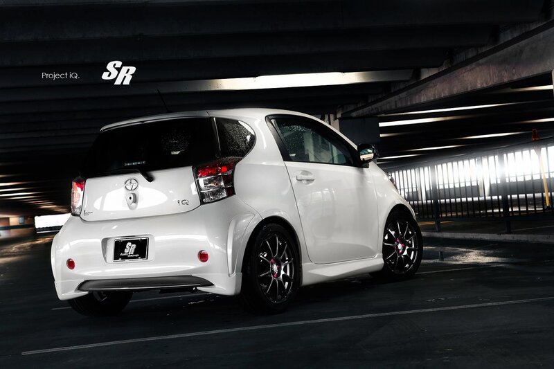 White Toyota iQ in parking garage