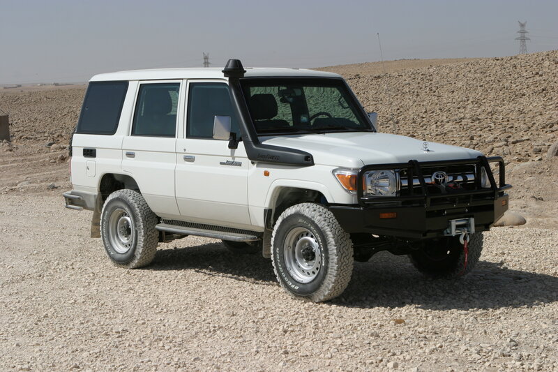 White Toyota Land Cruiser — Arid