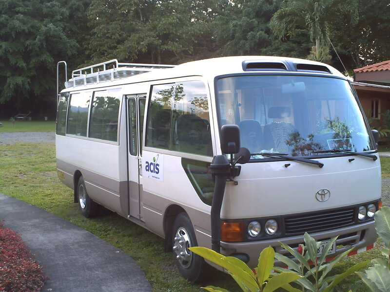 White Toyota minibus on grass